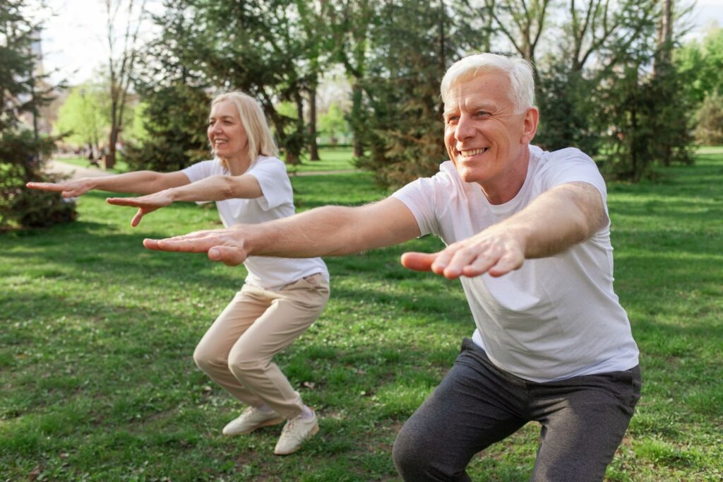 An older woman and man do balance exercises outside